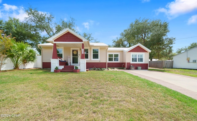 view of front of property with a porch and a front lawn