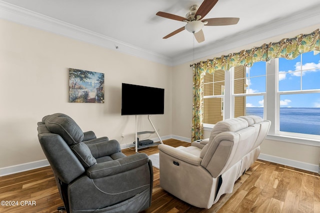 living room featuring ceiling fan, hardwood / wood-style flooring, and crown molding