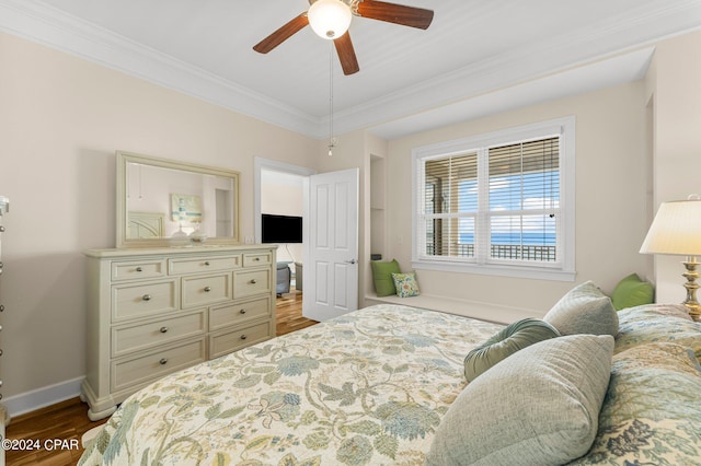 bedroom featuring wood-type flooring, crown molding, and ceiling fan