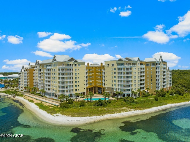 view of property with a view of the beach and a water view