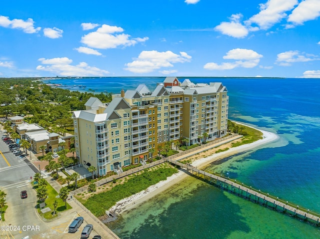 drone / aerial view featuring a water view and a beach view