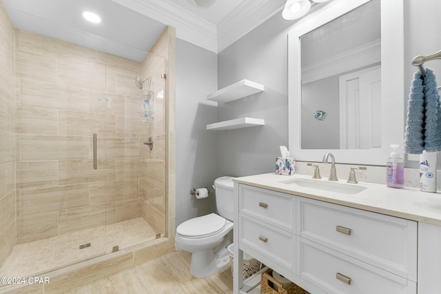 bathroom with ornamental molding, a shower with door, vanity, and toilet