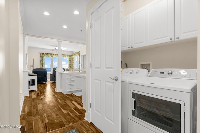 clothes washing area with separate washer and dryer, dark hardwood / wood-style flooring, ceiling fan, cabinets, and sink