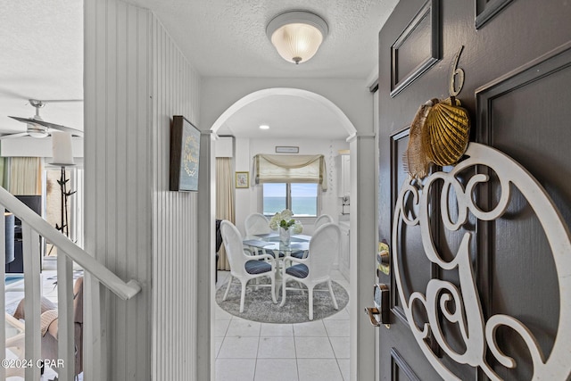 23223 Front Beach Rd Unit Ph-06, Panama City Beach, FL 32413 - entryway with arched walkways, light tile patterned floors, a textured ceiling, and a ceiling fan