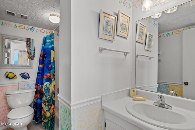 23223 Front Beach Rd Unit Ph-06, Panama City Beach, FL 32413 - bathroom with a textured ceiling, toilet, vanity, and curtained shower