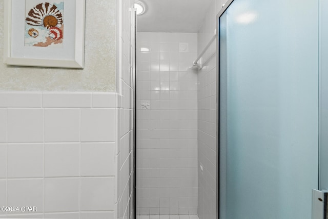 bathroom featuring a shower with shower door