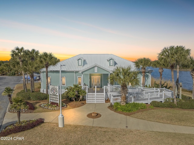 23223 Front Beach Rd Unit Ph-06, Panama City Beach, FL 32413 - view of front of house featuring covered porch, a water view, and metal roof