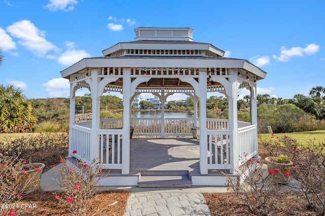 exterior space featuring a deck with water view and a gazebo