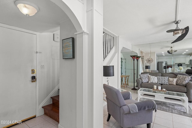 23223 Front Beach Rd Unit Ph-06, Panama City Beach, FL 32413 - tiled living area with a ceiling fan, stairway, and arched walkways