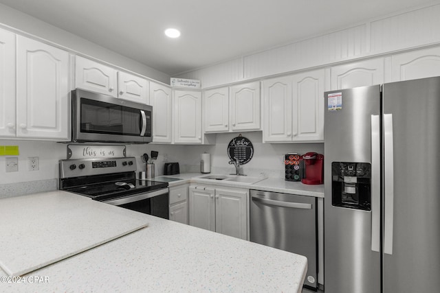 kitchen with white cabinetry, stainless steel appliances, and sink