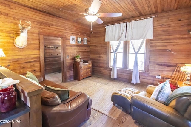 interior space with wood walls, light hardwood / wood-style flooring, ceiling fan, and wood ceiling