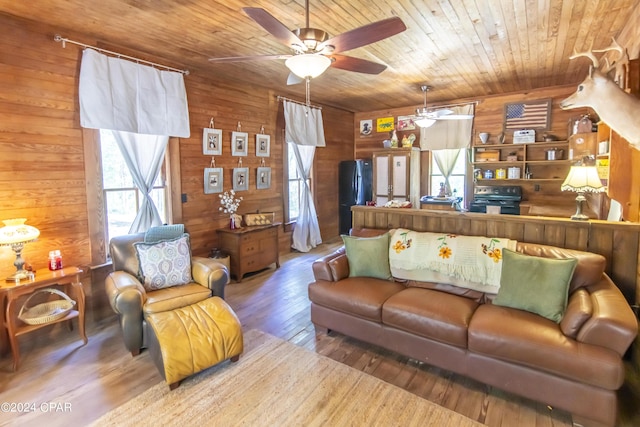 living room with wood walls, ceiling fan, wood ceiling, and hardwood / wood-style flooring