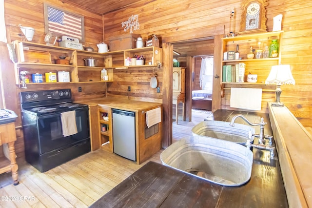 kitchen featuring wooden counters, electric range, dishwasher, light hardwood / wood-style floors, and wood walls