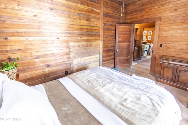 bedroom with wood walls