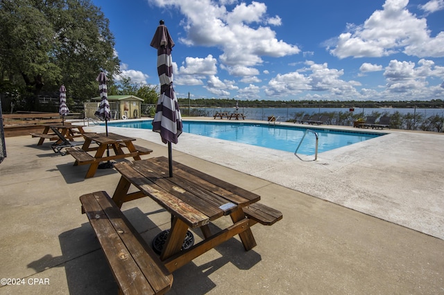 view of swimming pool featuring a patio area