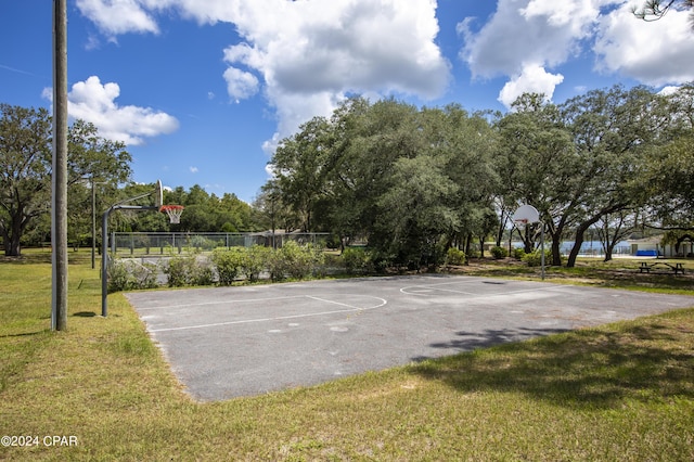 view of sport court featuring a yard