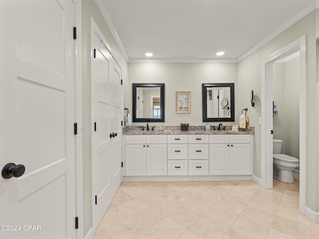 bathroom featuring toilet, ornamental molding, and vanity