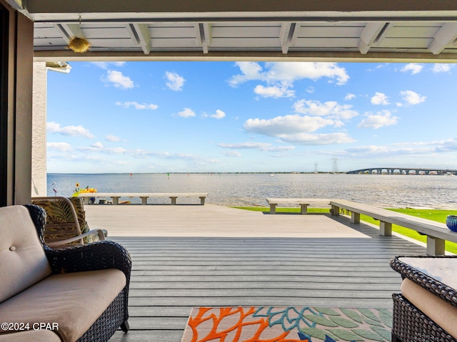 wooden terrace featuring a water view