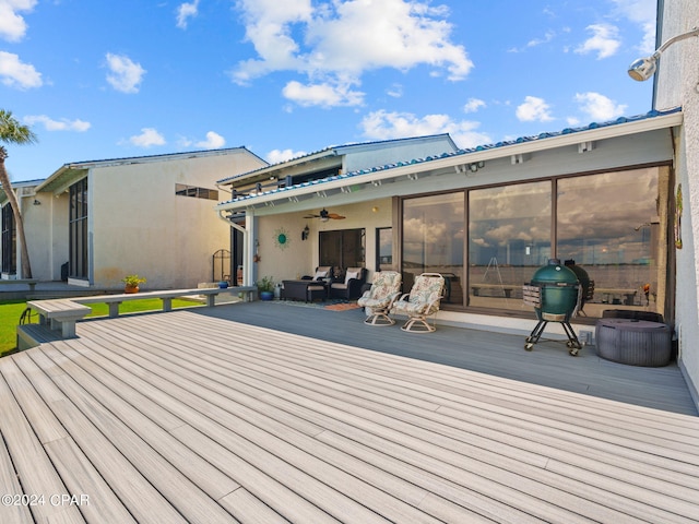 wooden terrace featuring ceiling fan