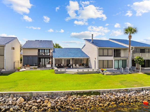 back of house featuring a yard, a patio area, and a balcony