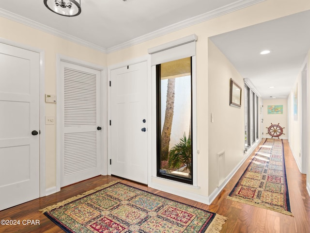 foyer entrance with ornamental molding, hardwood / wood-style flooring, and a healthy amount of sunlight