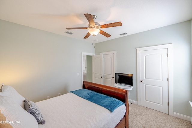 bedroom with light carpet, visible vents, and baseboards