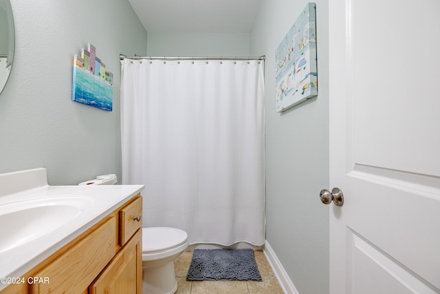 bathroom featuring tile patterned flooring, a shower with shower curtain, vanity, and toilet