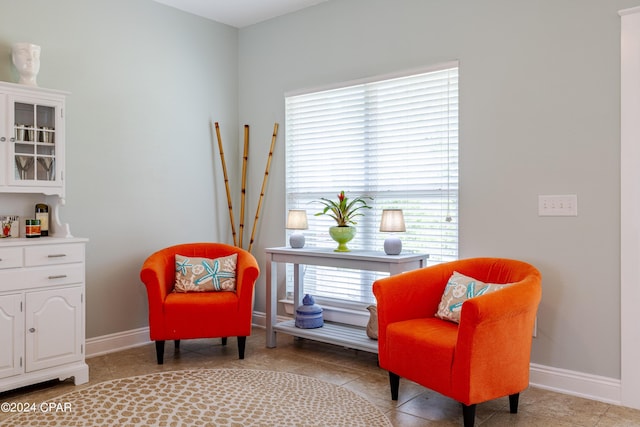 sitting room with light tile patterned floors and baseboards