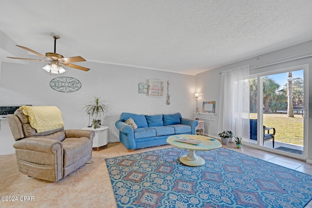 living room with a textured ceiling, light tile patterned flooring, and ceiling fan