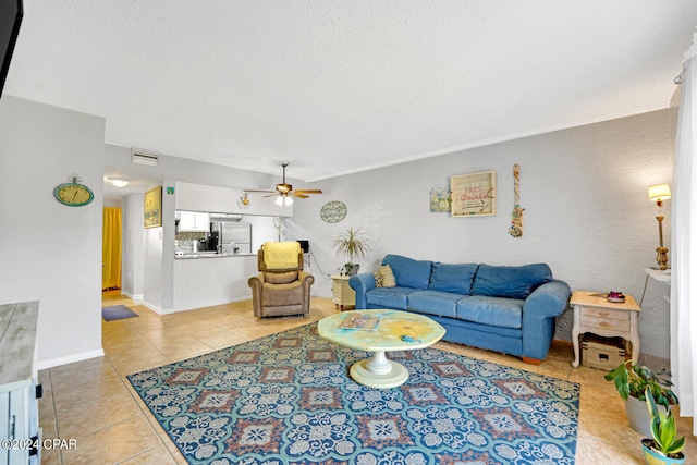 living room with light tile patterned flooring, a textured ceiling, and ceiling fan