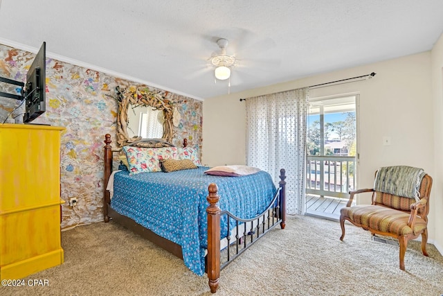 bedroom with access to exterior, a textured ceiling, carpet floors, and ceiling fan