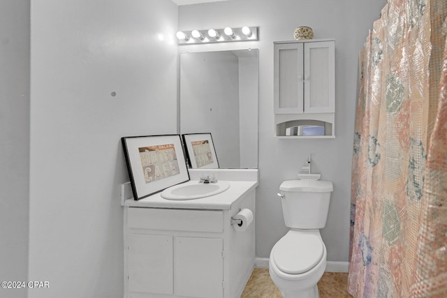 bathroom with vanity, tile patterned floors, and toilet