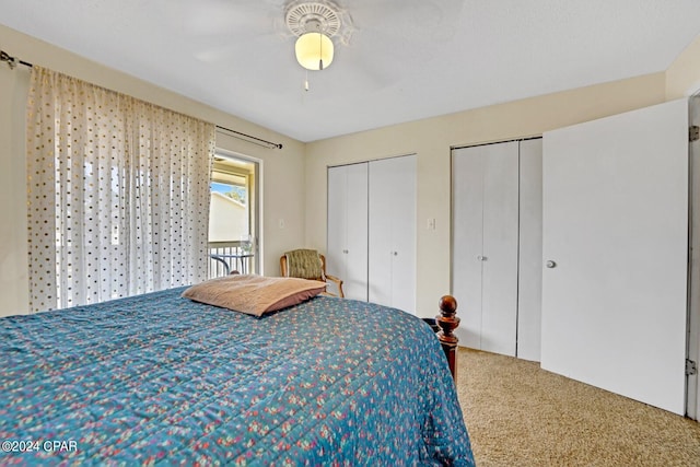 bedroom featuring ceiling fan, multiple closets, and carpet floors