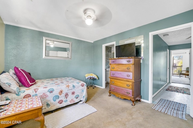 bedroom with ornamental molding, ensuite bath, light carpet, and ceiling fan