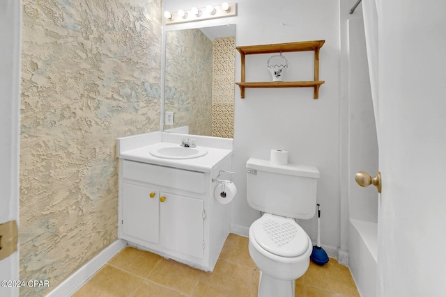 bathroom with toilet, vanity, and tile patterned floors