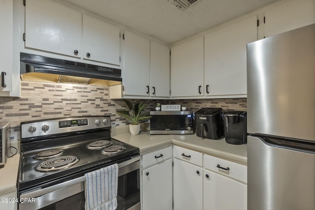 kitchen with appliances with stainless steel finishes, white cabinets, and decorative backsplash