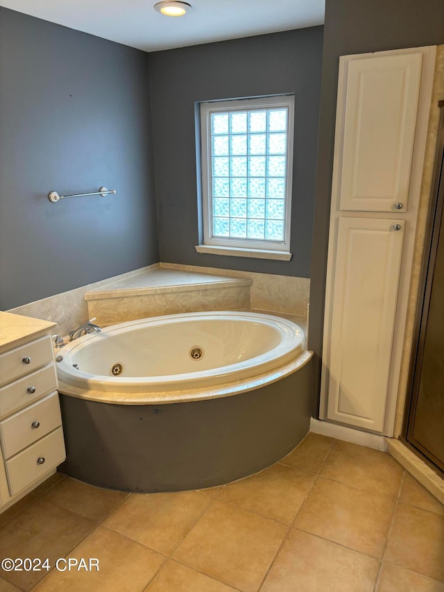 bathroom featuring a bath, vanity, and tile patterned floors