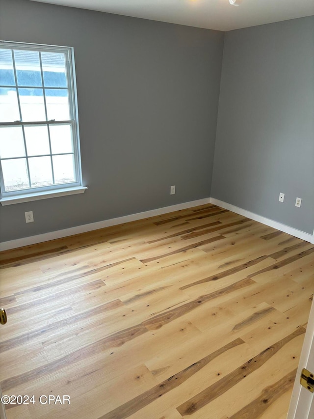 unfurnished room with light hardwood / wood-style floors