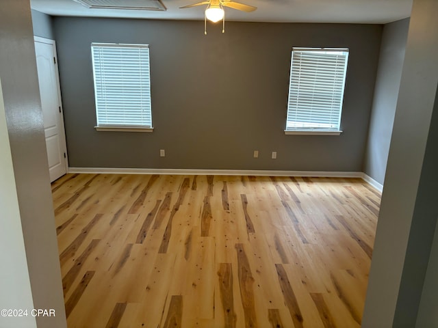 empty room with light wood-type flooring and ceiling fan