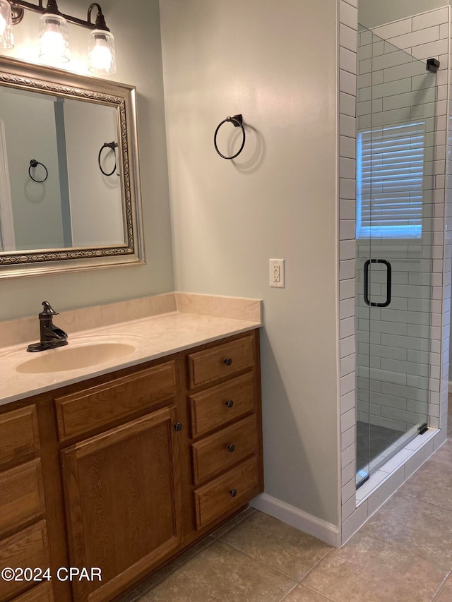 bathroom featuring walk in shower, tile patterned flooring, and vanity