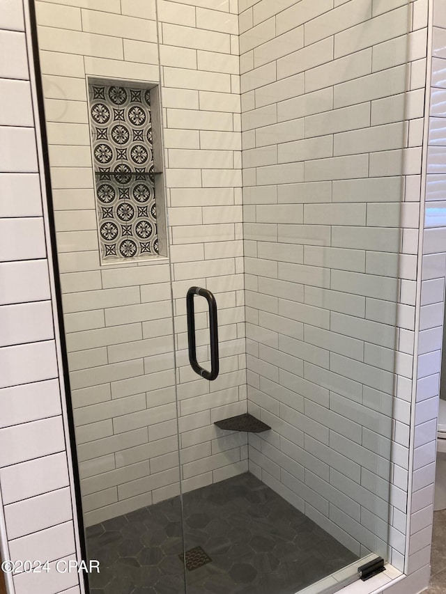 full bathroom featuring a shower stall