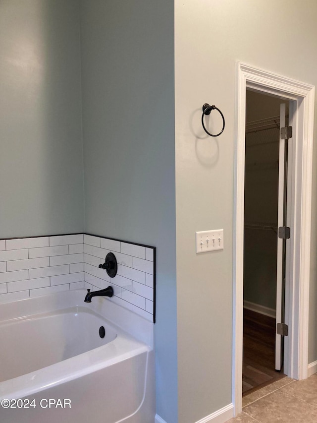 bathroom featuring tile patterned flooring and a washtub