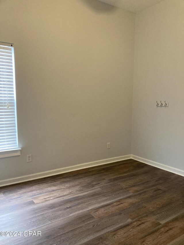 spare room with dark hardwood / wood-style flooring