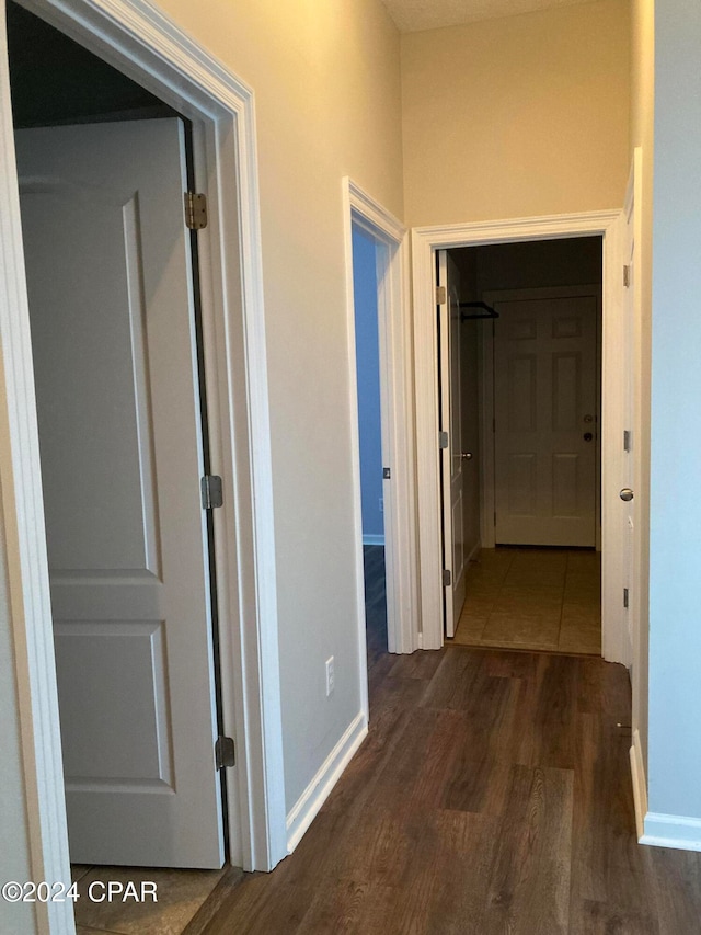 corridor featuring dark wood-type flooring