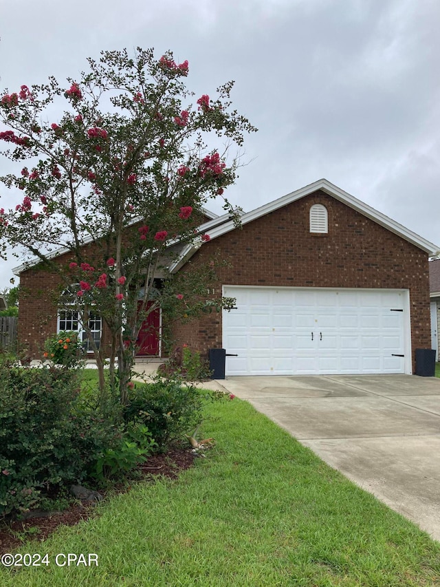 view of front of home with a garage and a front yard