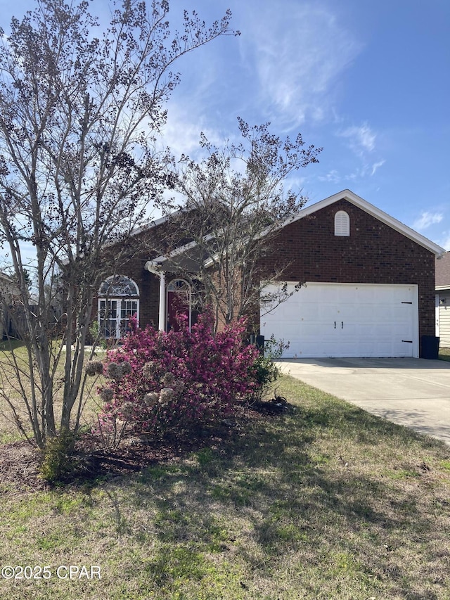 single story home featuring an attached garage, concrete driveway, and brick siding