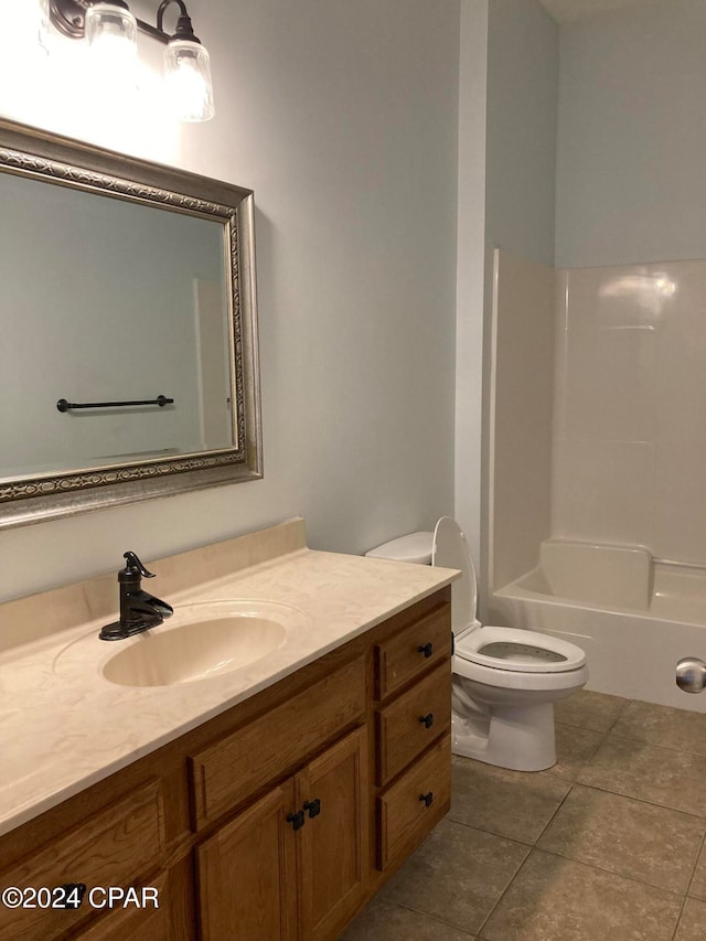 full bathroom featuring toilet, bathing tub / shower combination, vanity, and tile patterned flooring