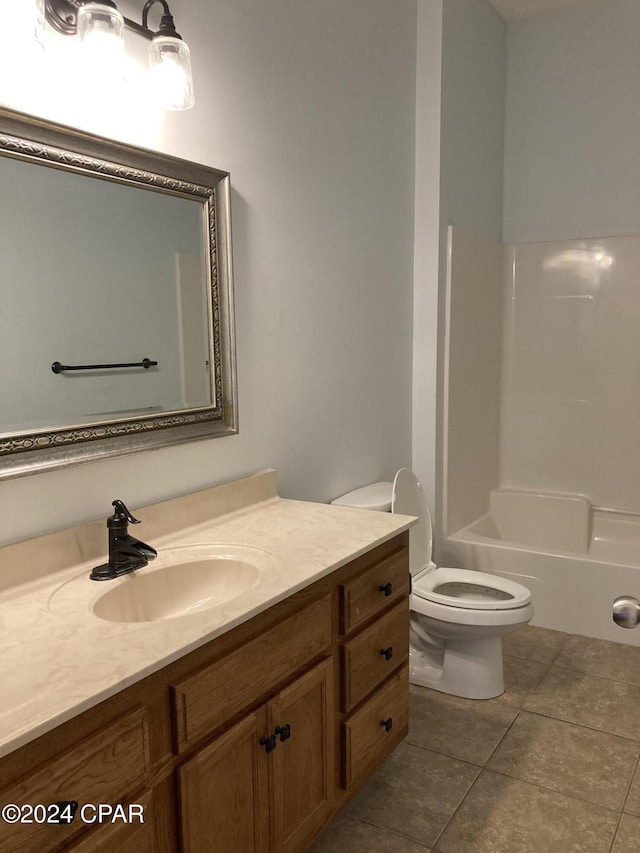 full bath with tile patterned flooring, bathtub / shower combination, vanity, and toilet