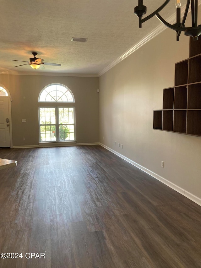 unfurnished living room featuring a textured ceiling, dark hardwood / wood-style flooring, ceiling fan, and crown molding