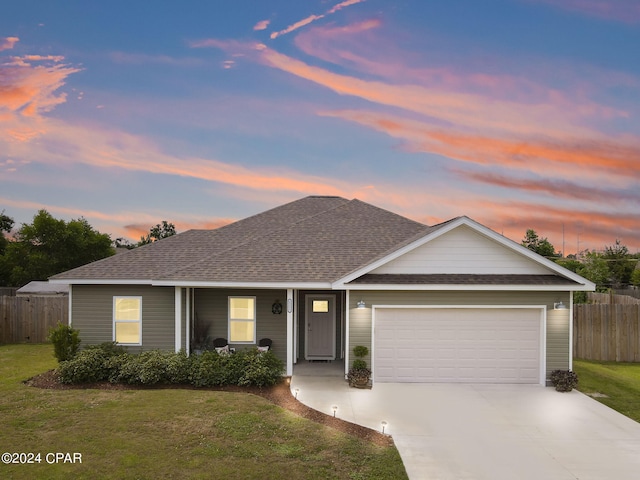 single story home with a yard and a garage